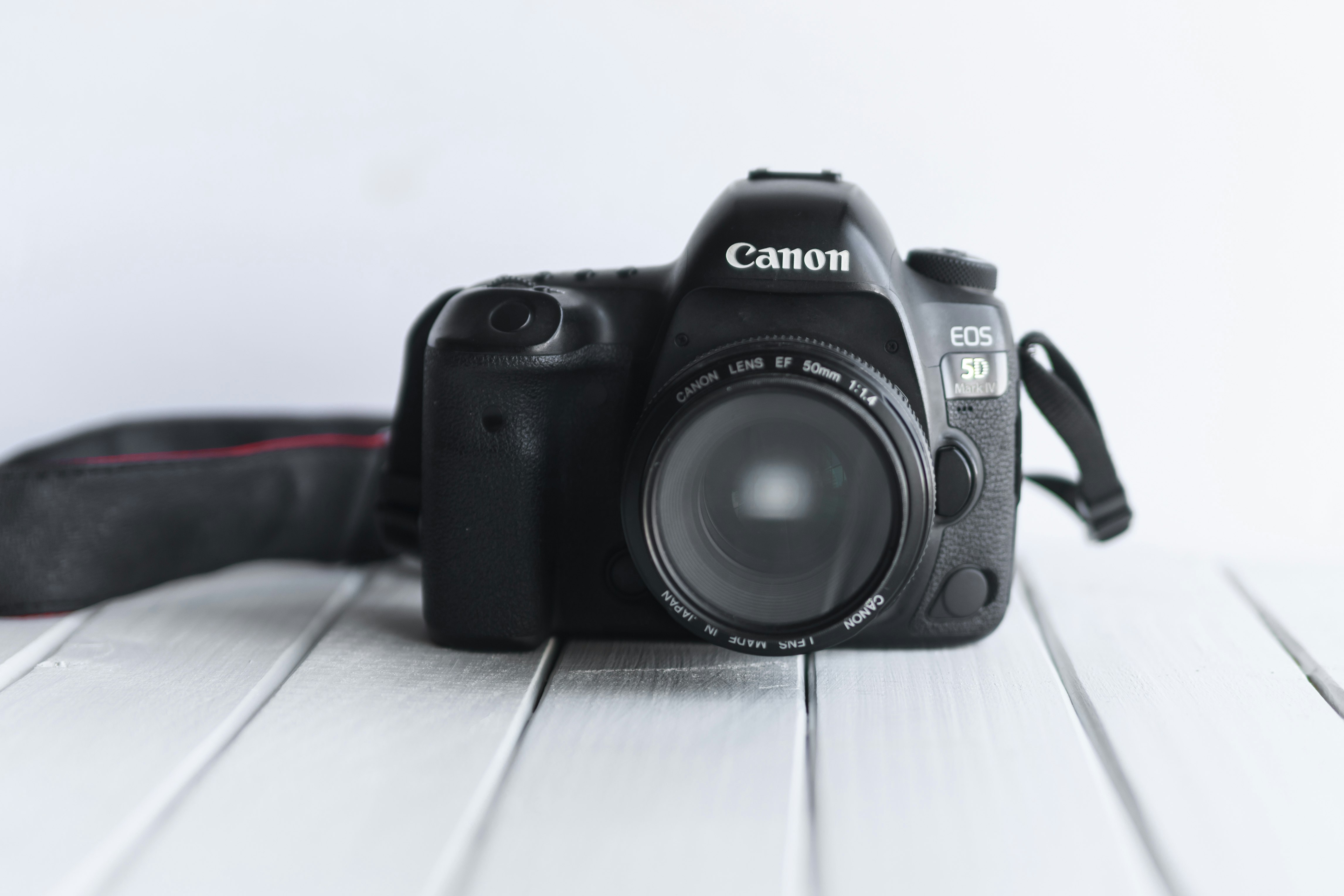 black nikon dslr camera on white table